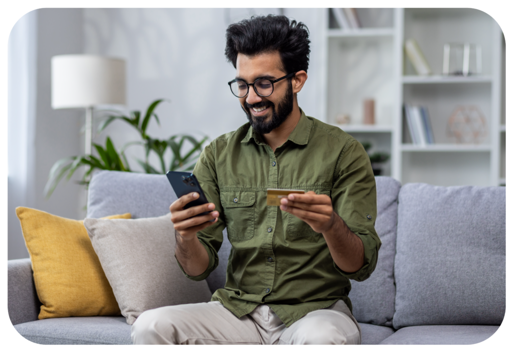 man happily paying his bill on his phone online